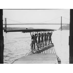 Eight Man Crew Team on Jetty Holding Shell Overhead, Silhouette 