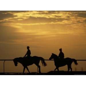  Silhouetted Men Riding on Horses, Dubai, UAE Premium 